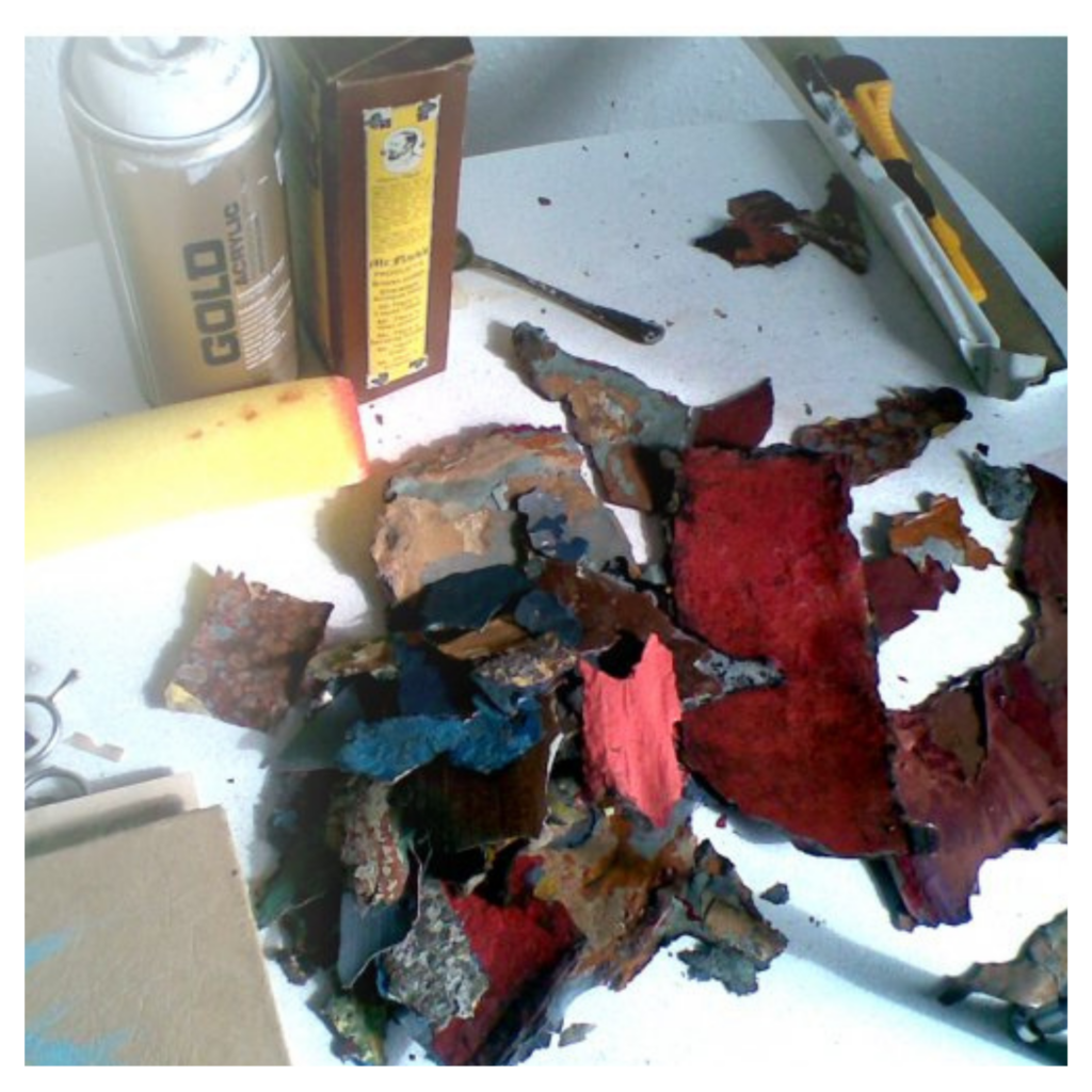 Scattered paint and plaster fragments in an art studio.