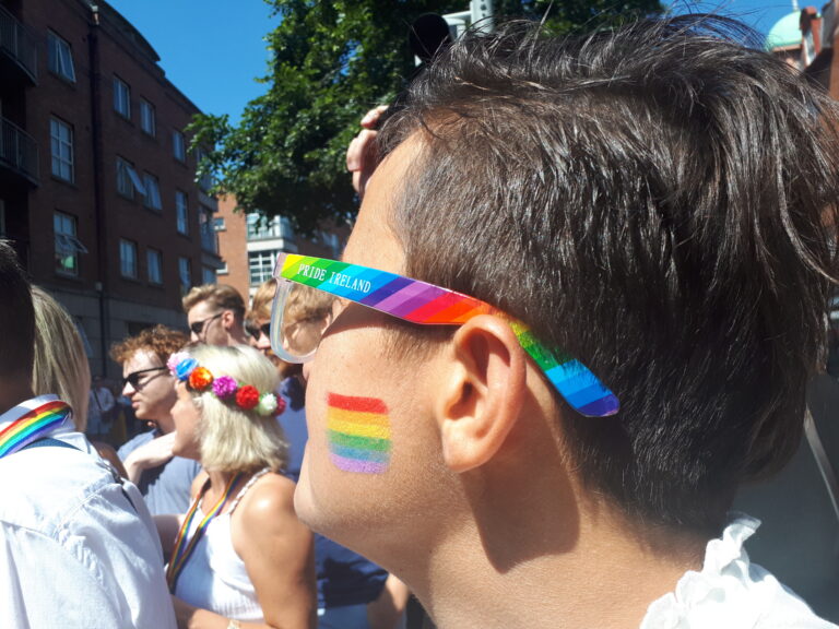 a profile of a person wearing rainbow glasses during Dublin Pride Parade 2018. 3 years after Ireland same-sex marriage referendum.