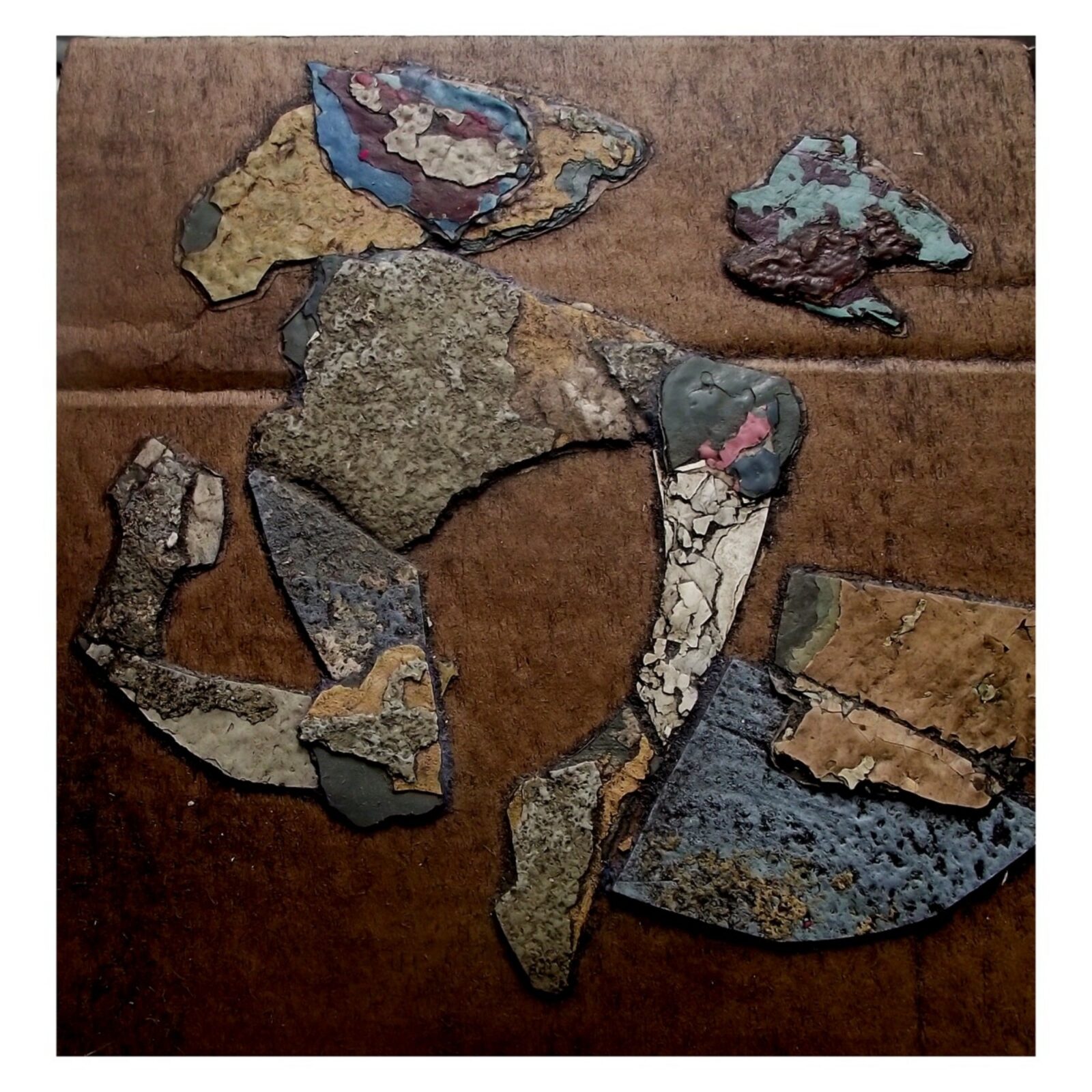 Mixed media artwork created from layers of old plaster and paint fragments on cardboard.